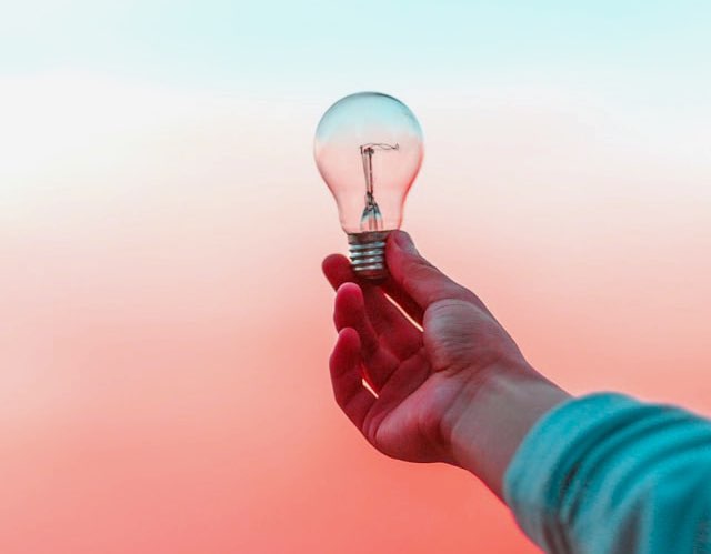 holding a light bulb, Inside my art studio, developing a concept holding a light bulb, Inside my art studio, developing a concept