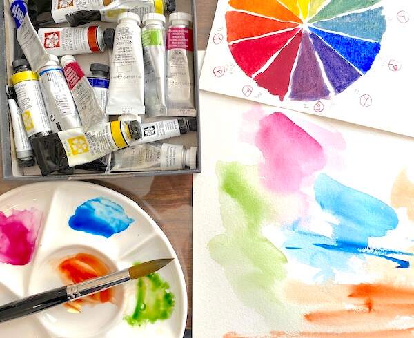 Watercolor tubes, palette, and color wheel. Inside my art studio. Watercolor tubes, palette, and color wheel. Inside my art studio.