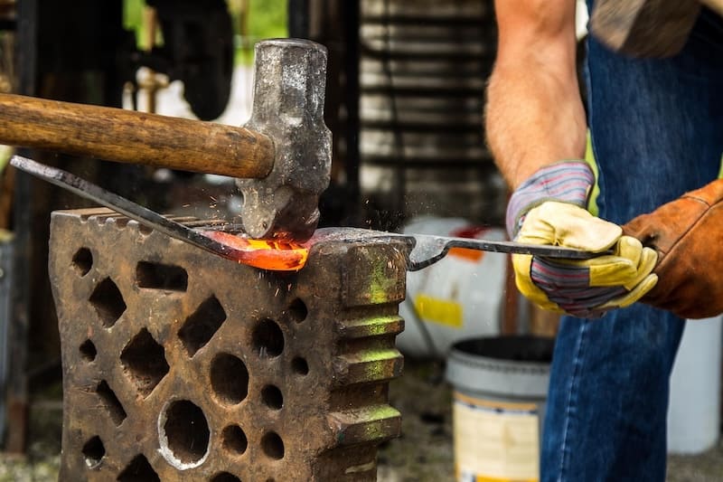 men hammering at the forge. Betzalel and oholiav the first jewish artists.